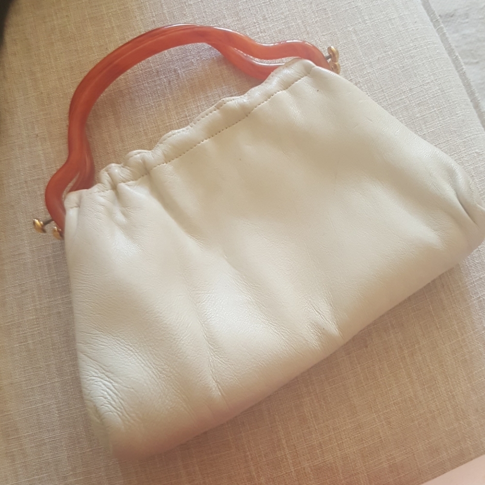 Vintage clutch with bakelite handles.